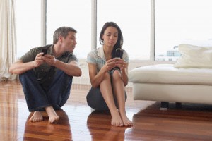 Couple with Cellular Phones in Condominium --- Image by © Radius Images/Corbis